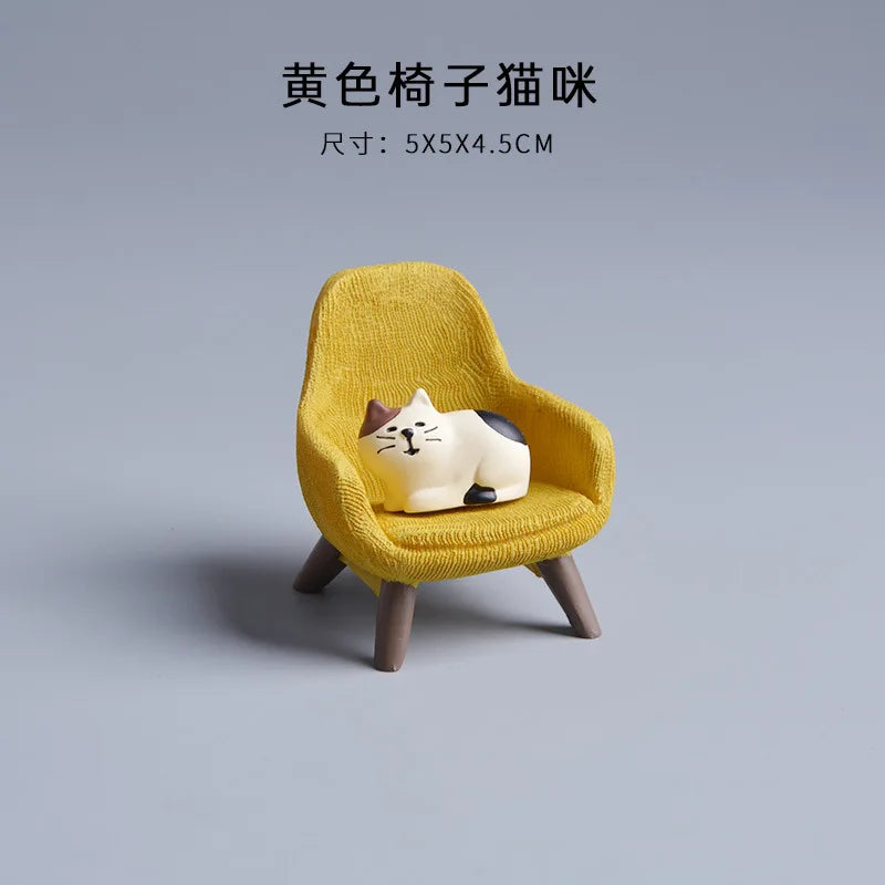 Small yellow chair with a cat-shaped cushion on a gray background.