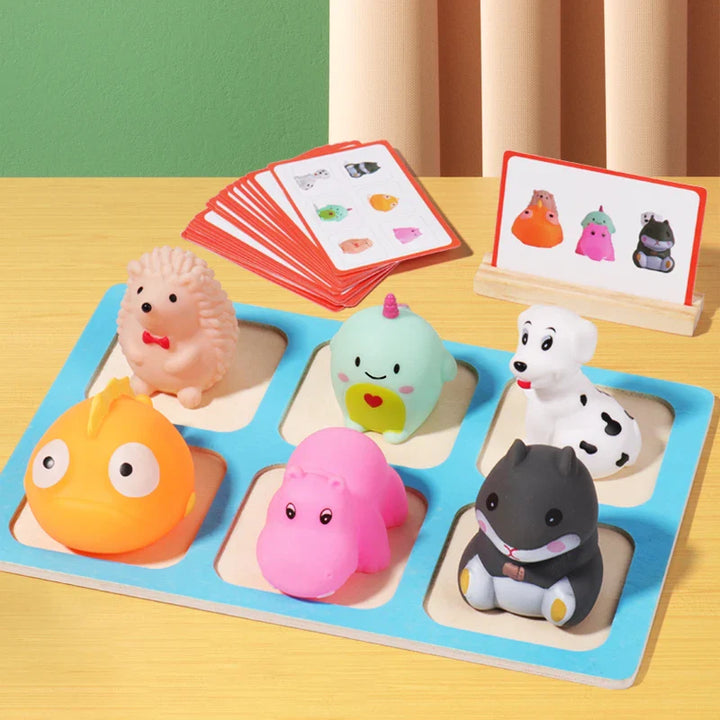 Set of colorful animal-shaped toys on a wooden board with matching cards in the background.