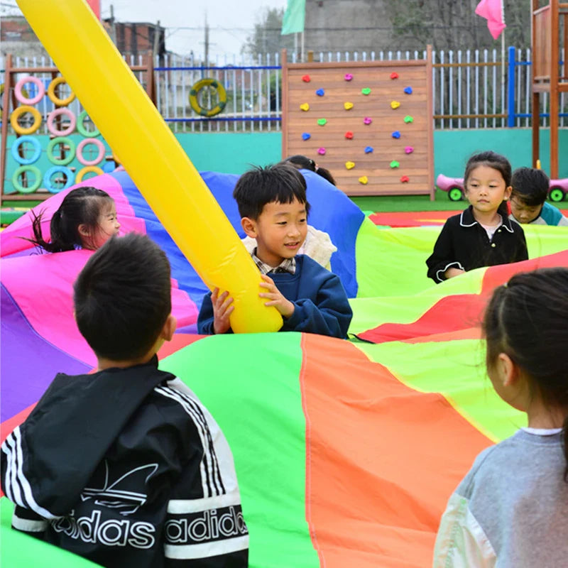 Children playing on a colorful inflatable slide at an outdoor playground.