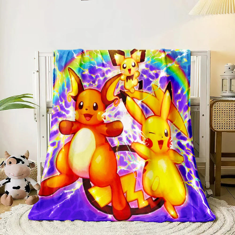 Colorful blanket with cartoon characters on a bed in a room.