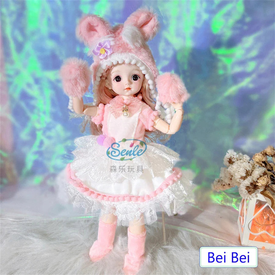 Toy doll in a pink outfit with fluffy ears against a colorful background.
