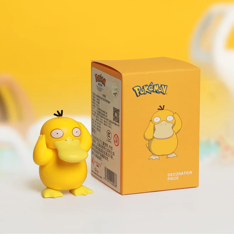 Yellow cartoon figurine next to its packaging with Pokémon branding on a yellow background.