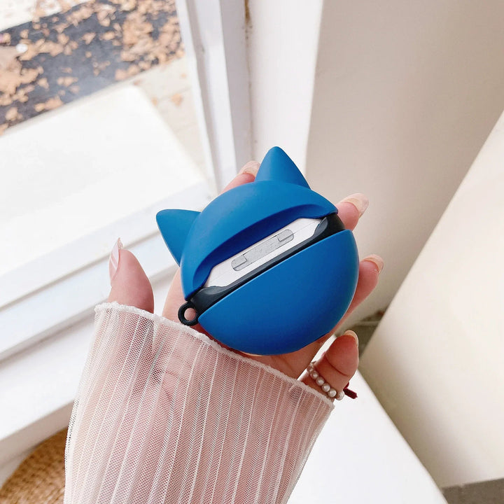 Blue wireless earbuds case with fox ears held by a hand against a neutral background.
