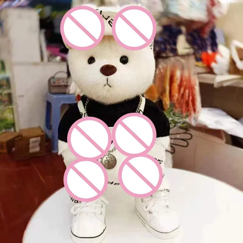 Teddy bear wearing a black outfit with white shoes in a store setting.