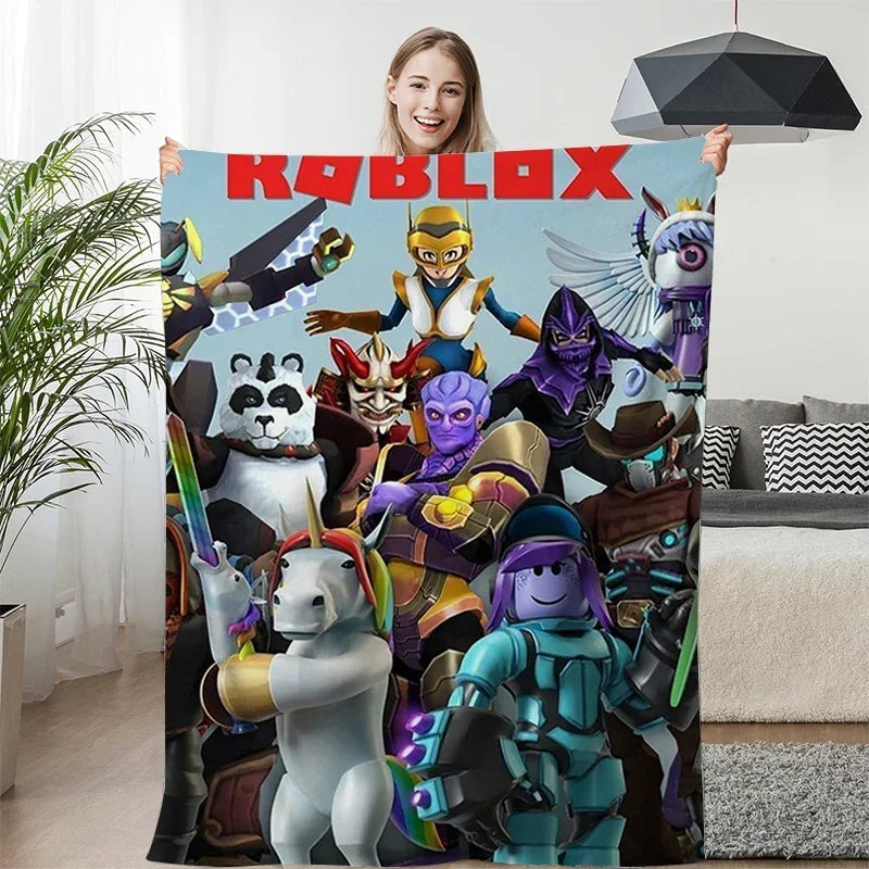 Person holding a Roblox-themed blanket with characters on a couch.