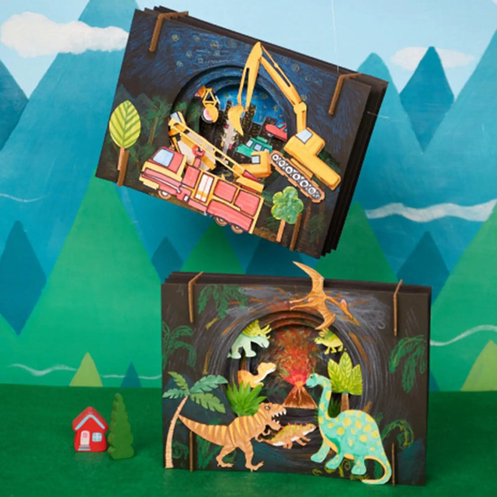 Two children's pop-up books with construction and dinosaur scenes against a colorful mountain background.