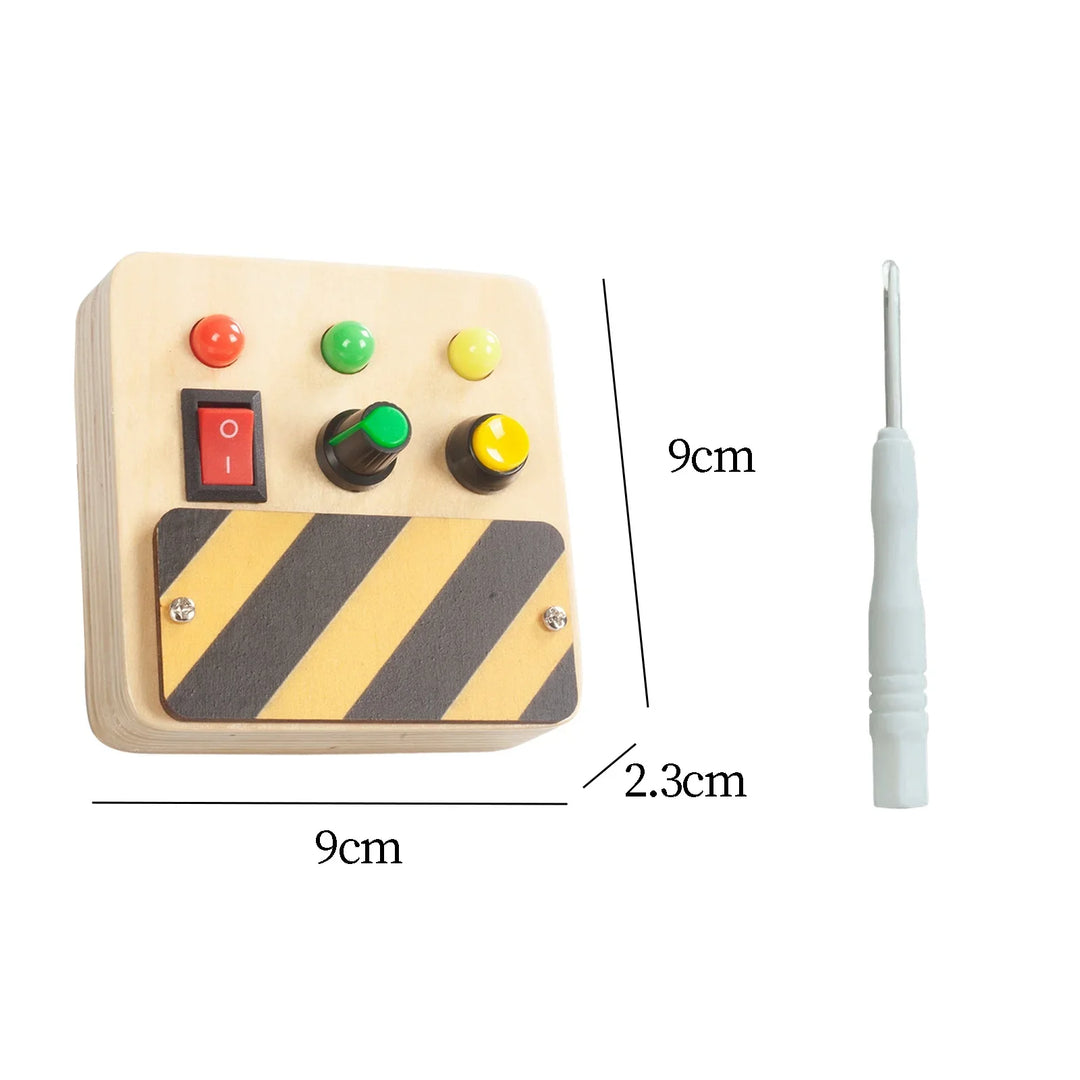 Control panel with colored buttons and a white tool, with measurements indicated.