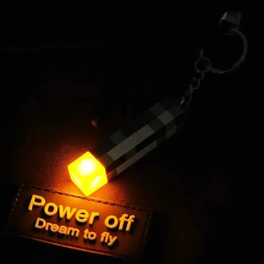 Keychain light with Power off Dream to fly text in the dark.