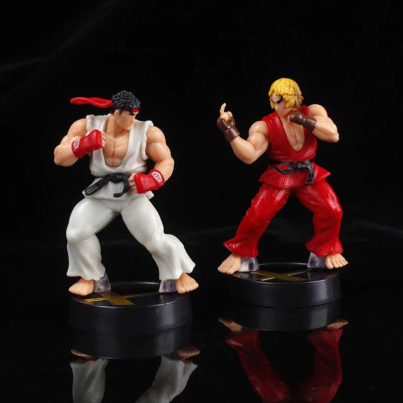 Two action figures on black bases against a dark background.