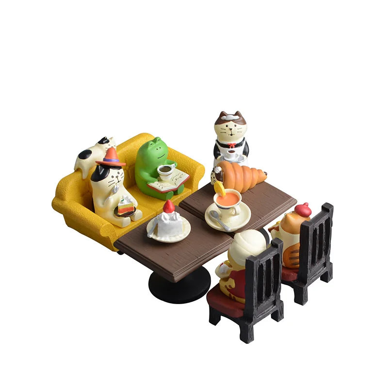 Set of miniature figurines of cats around a table with food and drinks on a white background.