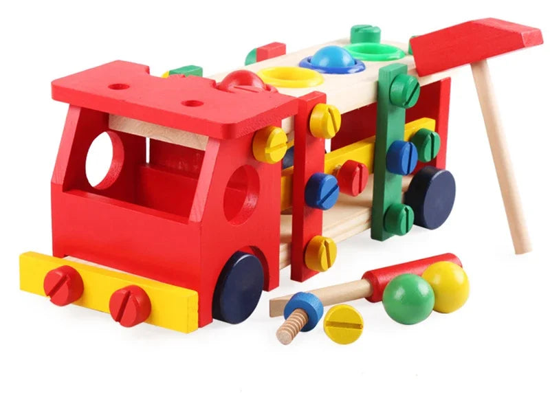 Colorful wooden toy with various shapes and a red truck-like structure on a white background.