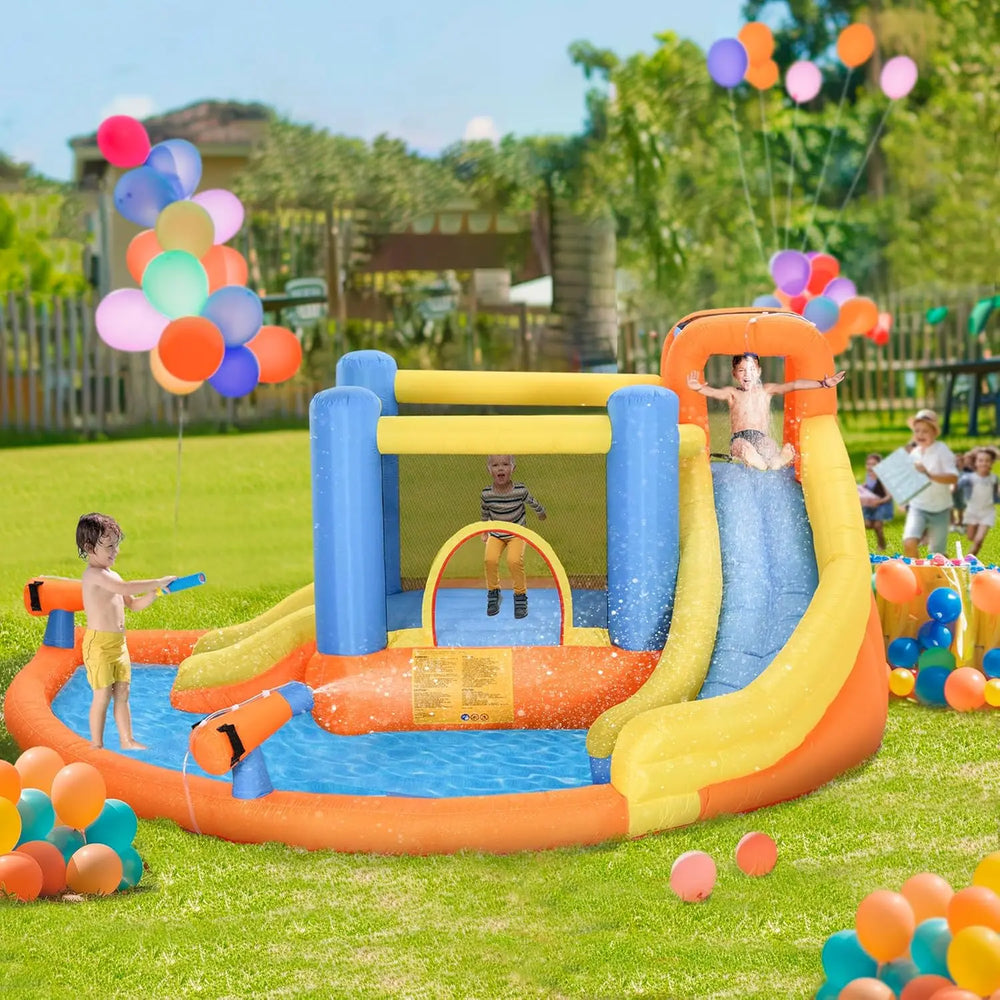 Children playing on an inflatable playground with balloons in a backyard.
