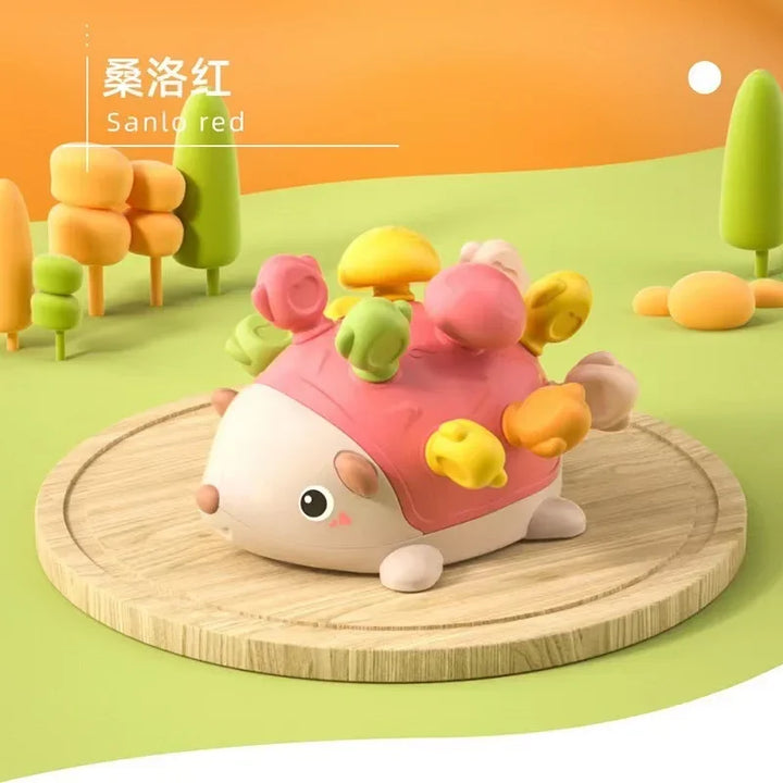 Colorful toy hedgehog on a wooden platform with a cartoon landscape in the background.