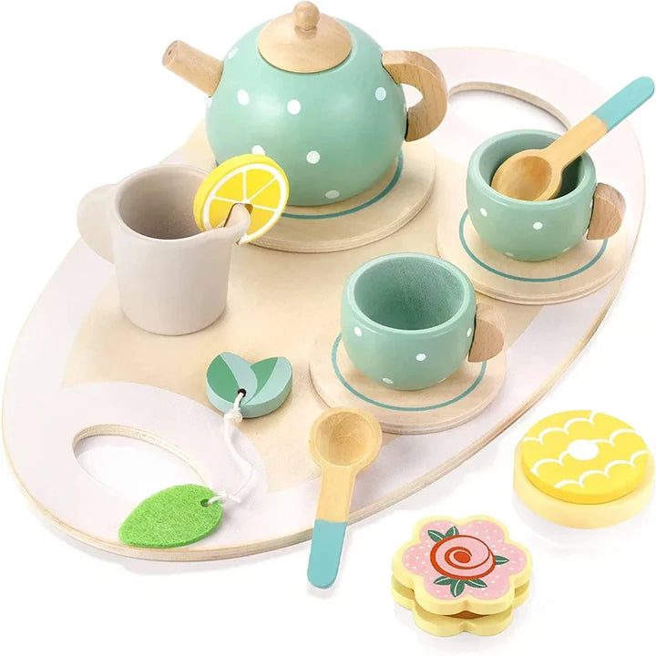 Children's toy tea set with polka dot teapot, cups, and utensils on a white tray.
