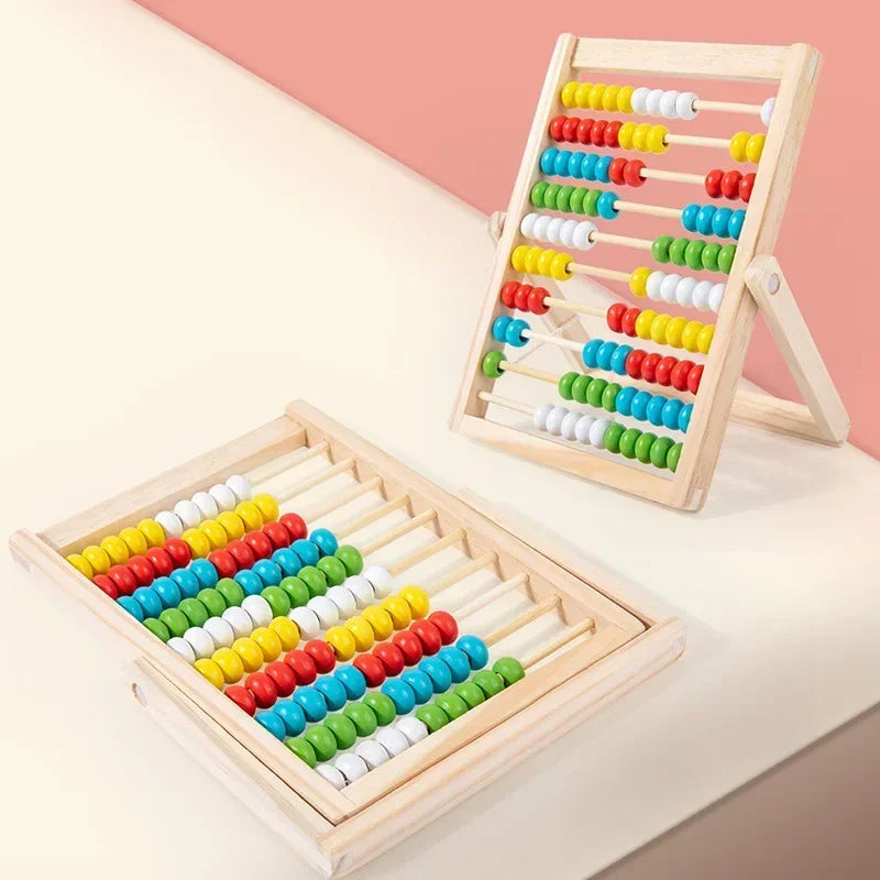 Colorful abacus toys on a light pink background.