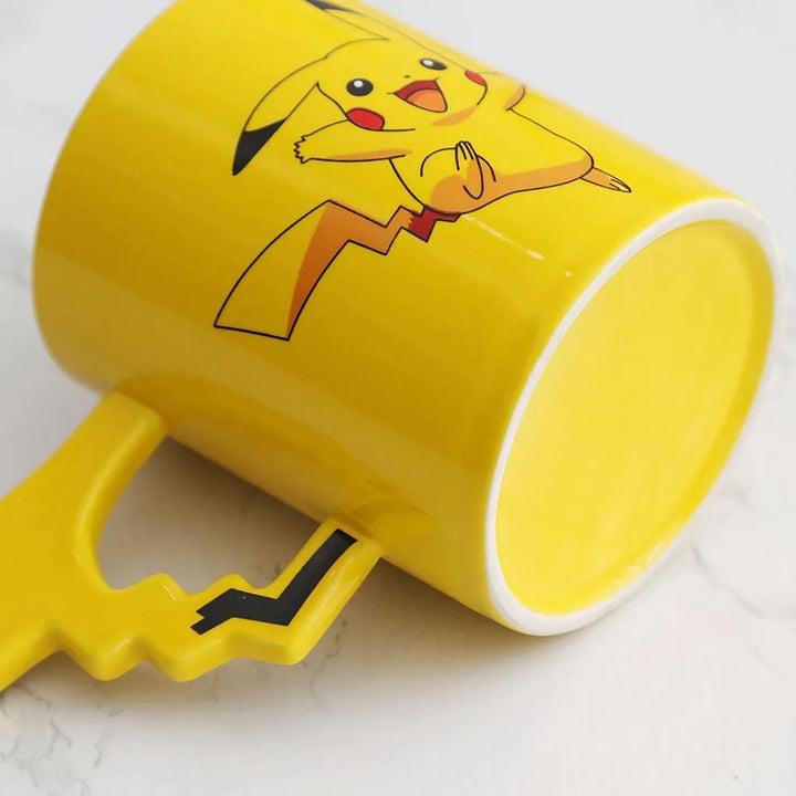 Yellow mug with Pikachu design on a white background.