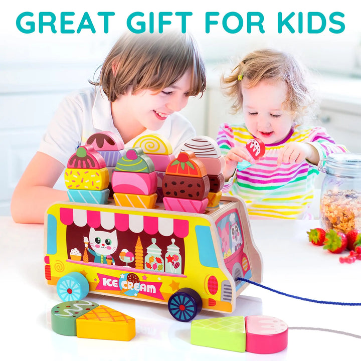 Children playing with a colorful ice cream truck toy set on a white surface.