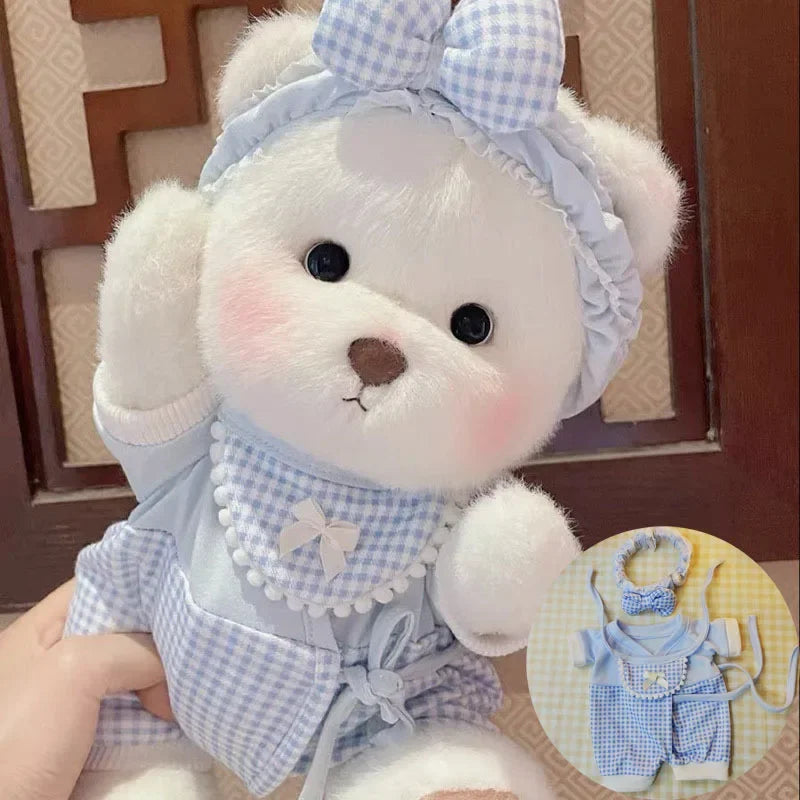 White teddy bear with a blue checkered outfit held by a person, with a matching outfit set displayed.