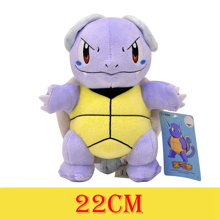 Plush toy of a character with a yellow shell and purple body, standing next to its packaging on a white background.