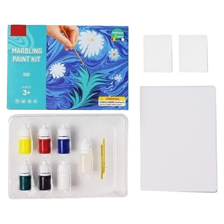 Marbling paint kit with paint bottles, a brush, and white paper on a white background.