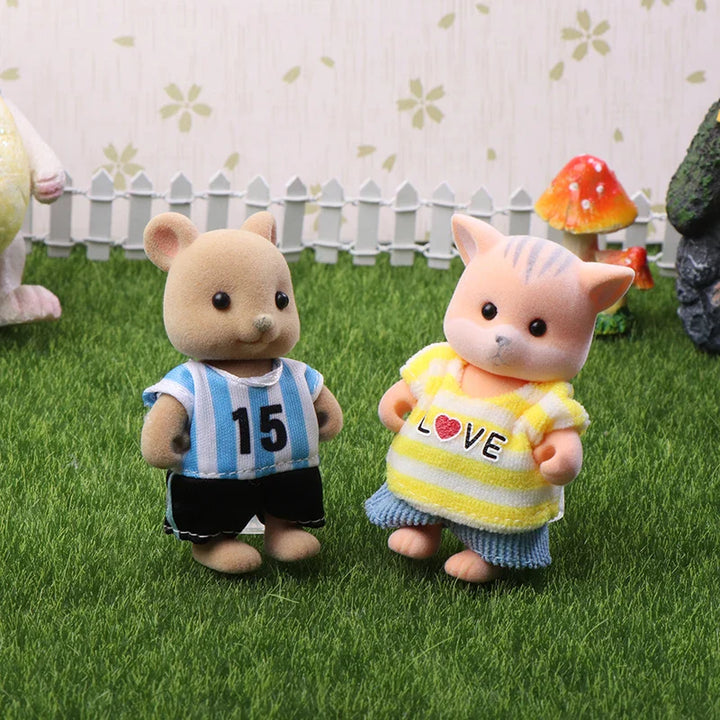 Two toy animals standing on grass with a decorative background.