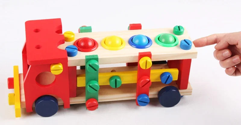 Colorful wooden toy train with variously shaped holes on a white background.