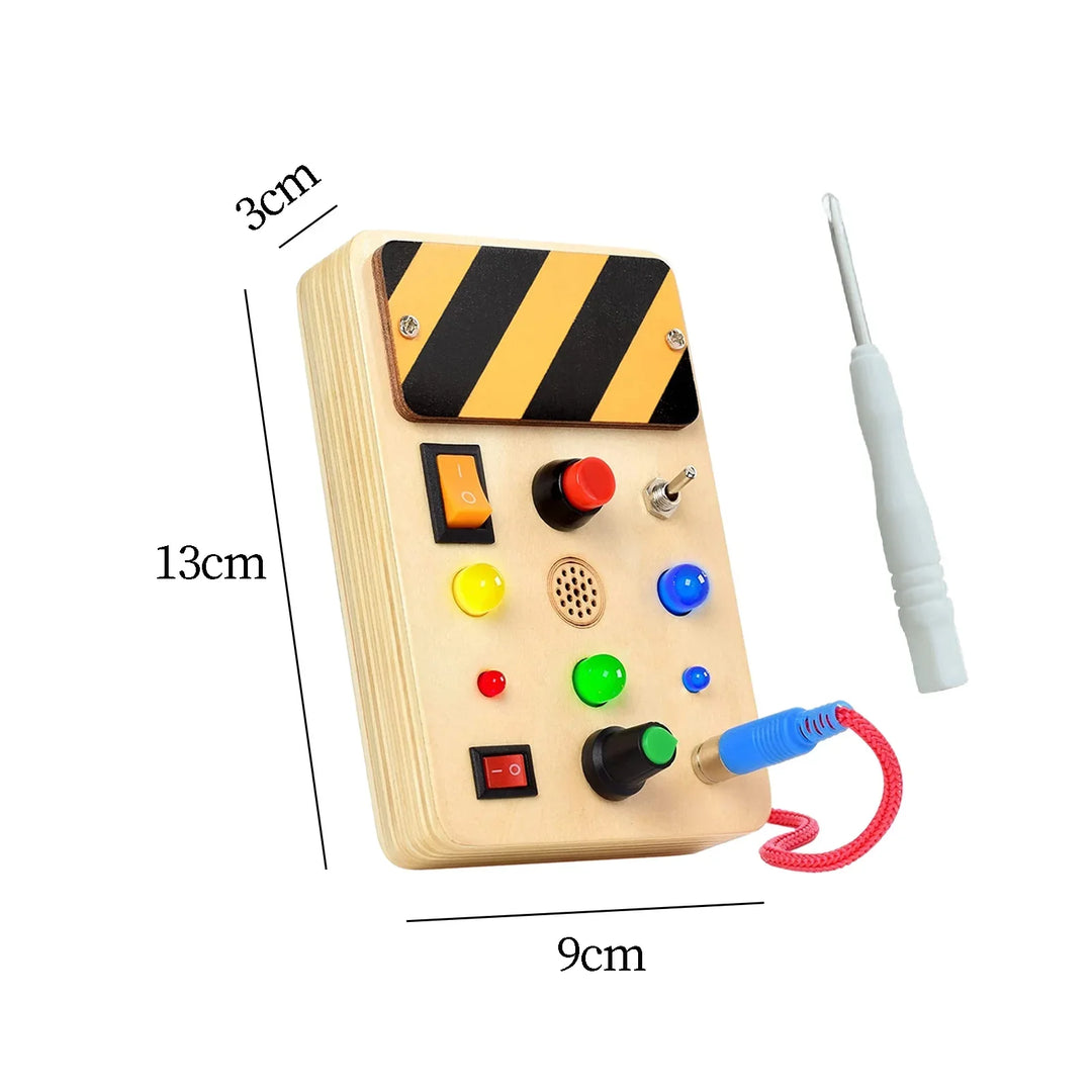 Toy control panel with colorful buttons and a measuring stick for dimensions on a white background.