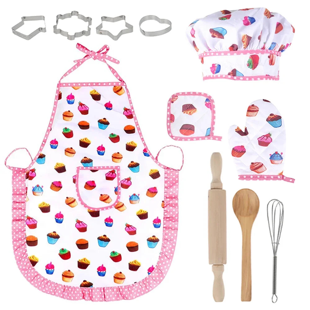 Children's baking set with apron, hat, oven mitts, cookie cutters, rolling pin, wooden spoon, and whisk on a white background.