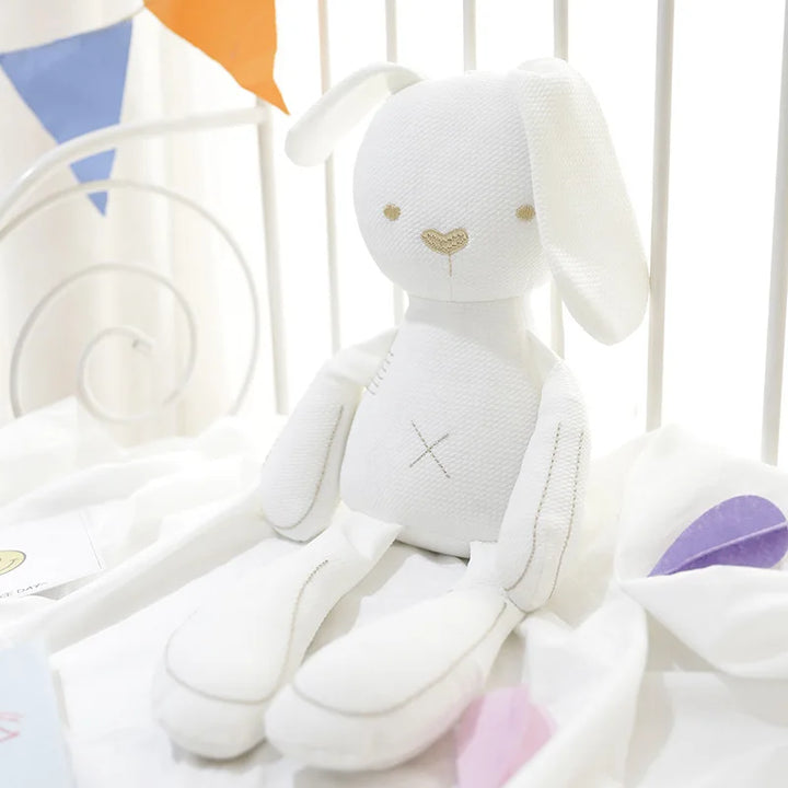 White plush toy with a heart design on a white background.