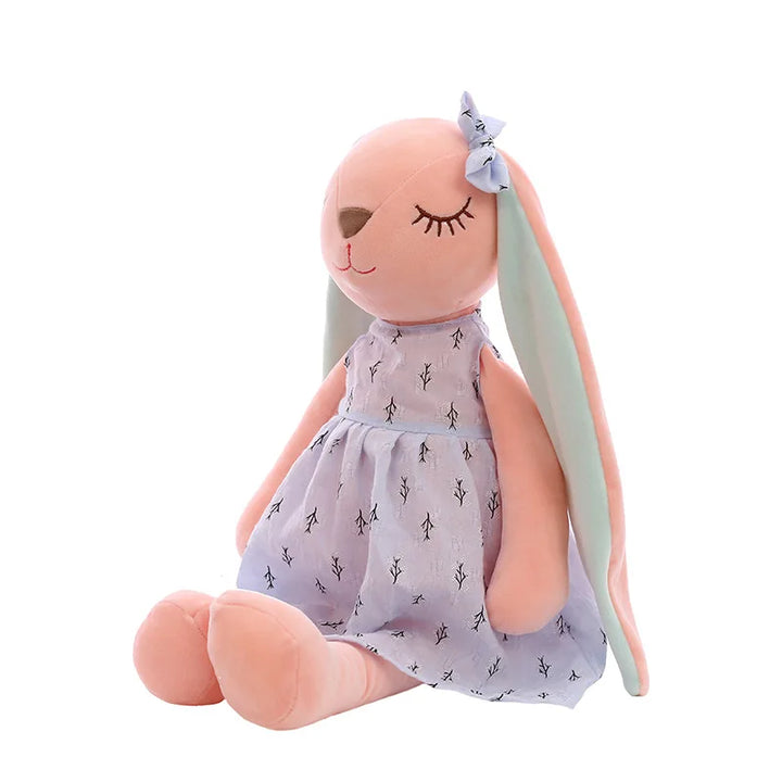 Plush toy rabbit in a dress with long ears on a white background.