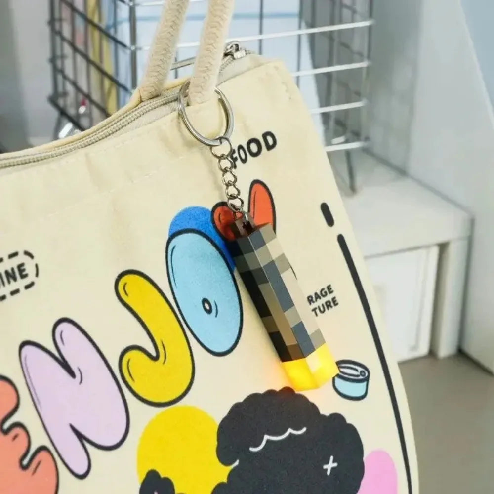 Colorful keychain attached to a bag with cartoon characters and text.