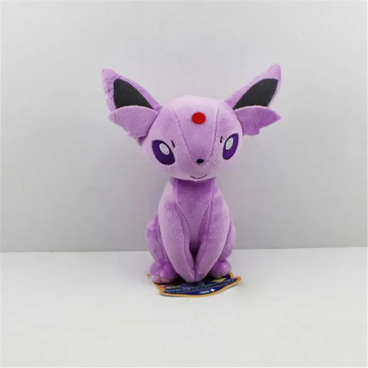 Purple plush toy with black ears and red circle on a white background.