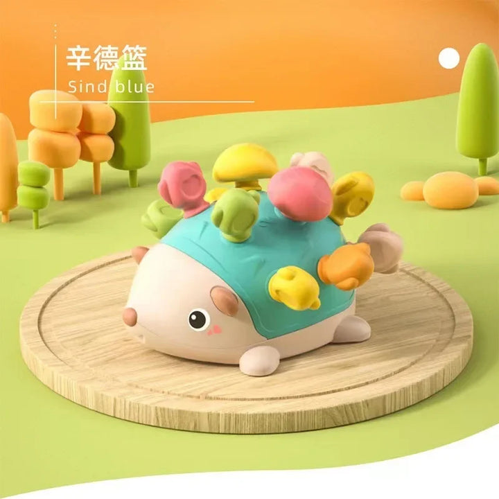 Colorful toy hedgehog with mushroom-shaped ears on a wooden platform against a bright background.