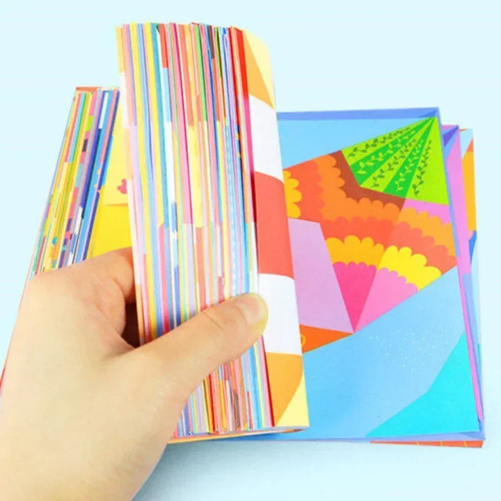 Colorful paper stacks with geometric patterns on a light blue background.