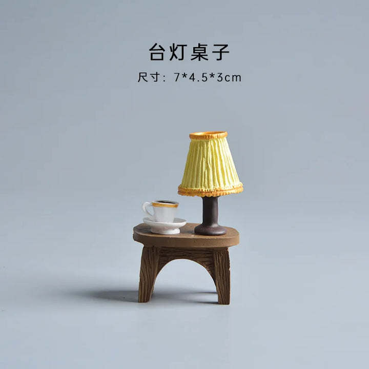 Small wooden table with a lamp and cup on a gray background.