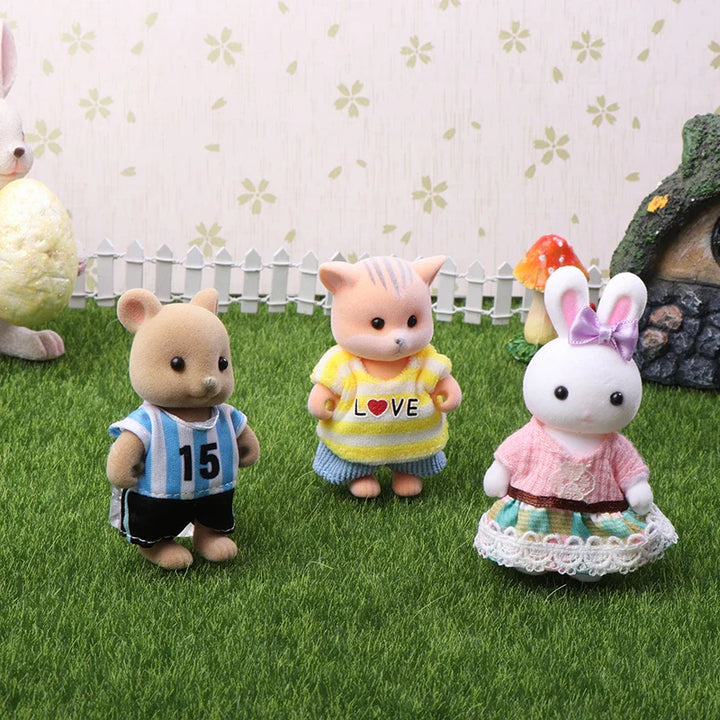 Three toy animals standing on grass with a decorative background.