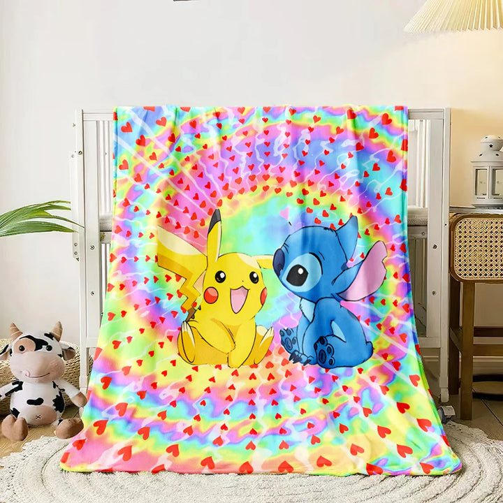 Colorful tie-dye blanket with cartoon characters on a bed in a room.