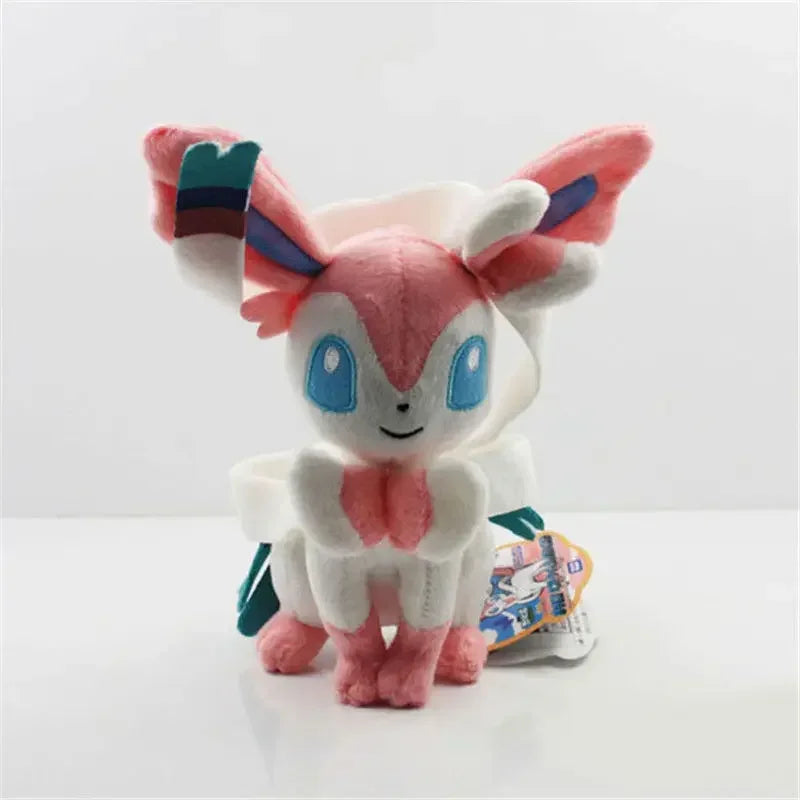Plush toy of a character with pink and white colors on a light gray background.