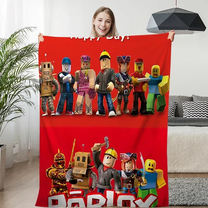 Person holding a red blanket with cartoon character design in a living room.