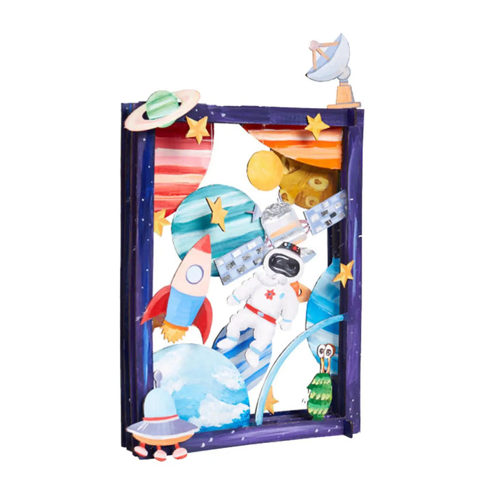 Colorful space-themed display with astronaut figure, rocket, and planets on a white background.