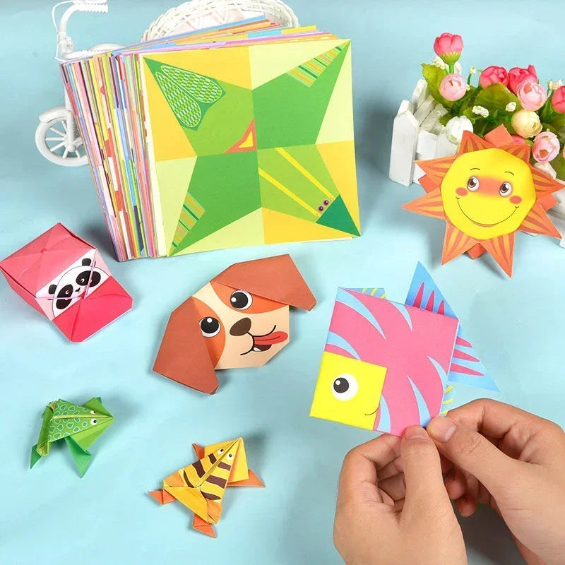Colorful paper crafts including a star, panda, dog, and fish on a light blue background.