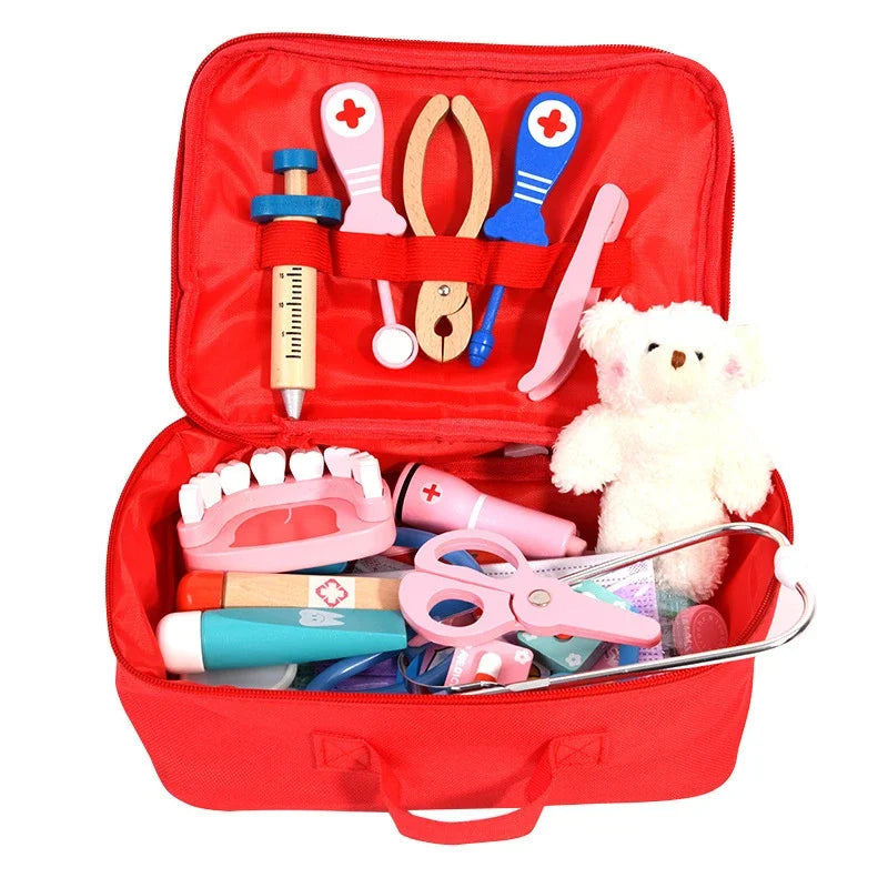 Red toy medical kit with various tools and a teddy bear on a white background.