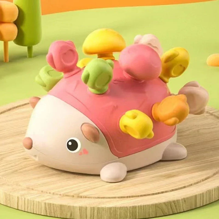 Colorful hedgehog-shaped toy with a soft texture on a wooden surface.