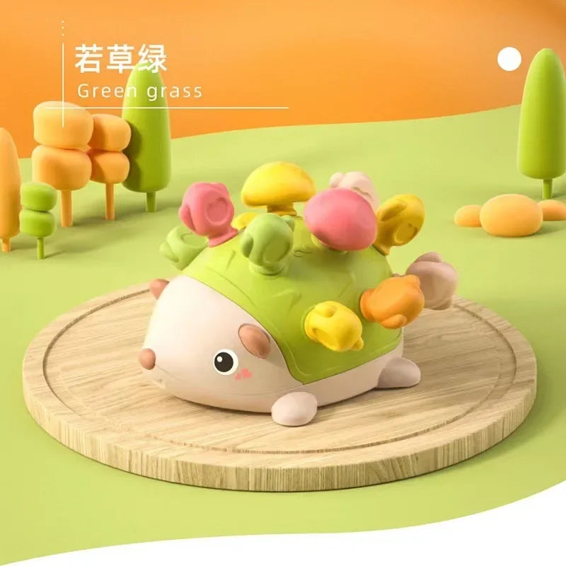 Colorful toy hedgehog on a wooden platform with a cartoon landscape in the background.