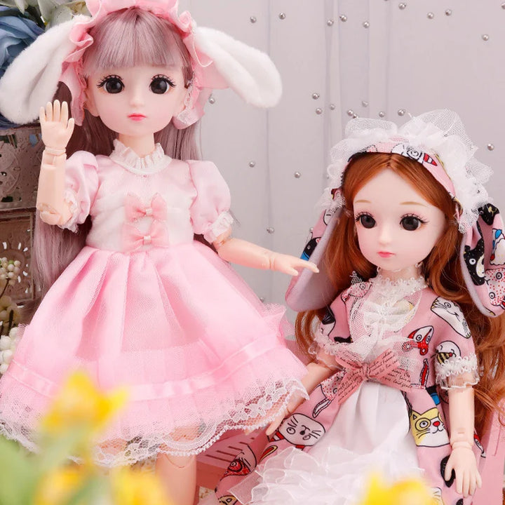 Two dolls in decorative outfits with a blurred background.
