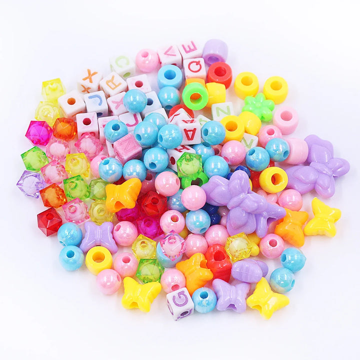 Assorted colorful beads on a white background.