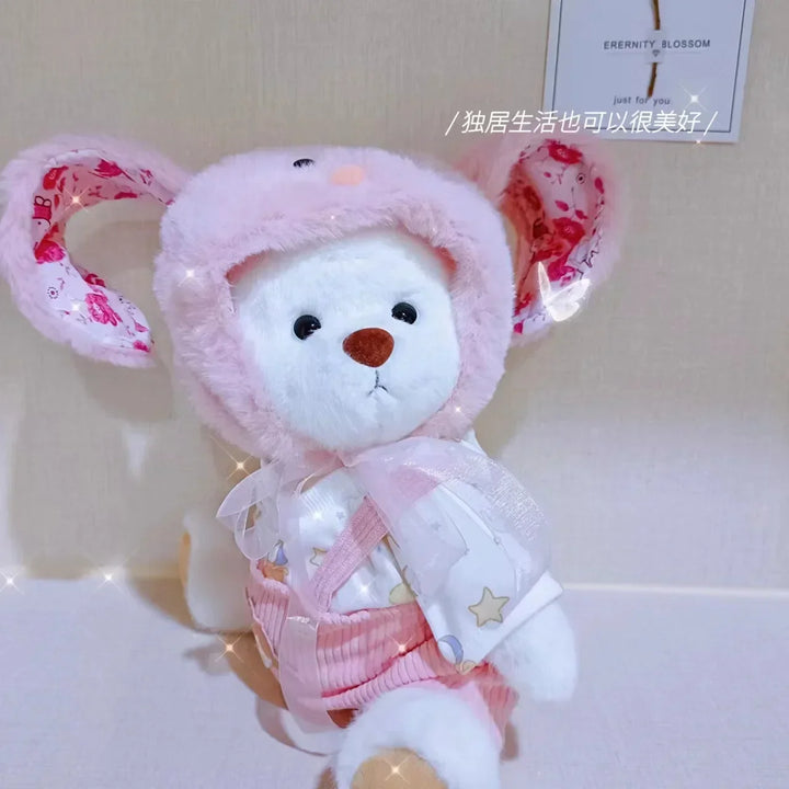 Plush toy with pink floral hat and outfit on a light background.