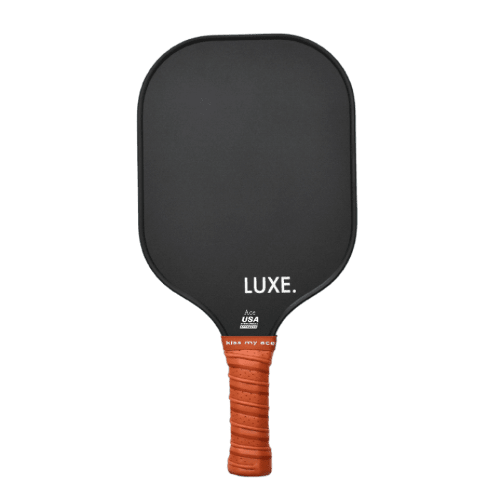 Black pickleball paddle with orange handle on a transparent background.