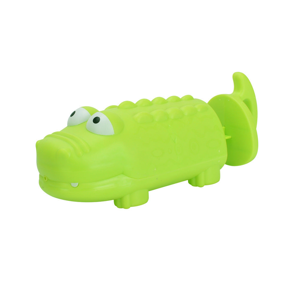 Green alligator toy on a white background.