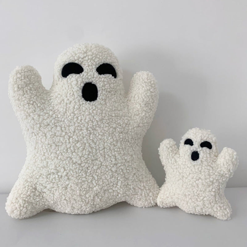 Two white ghost-shaped cushions with black eyes on a light gray background.